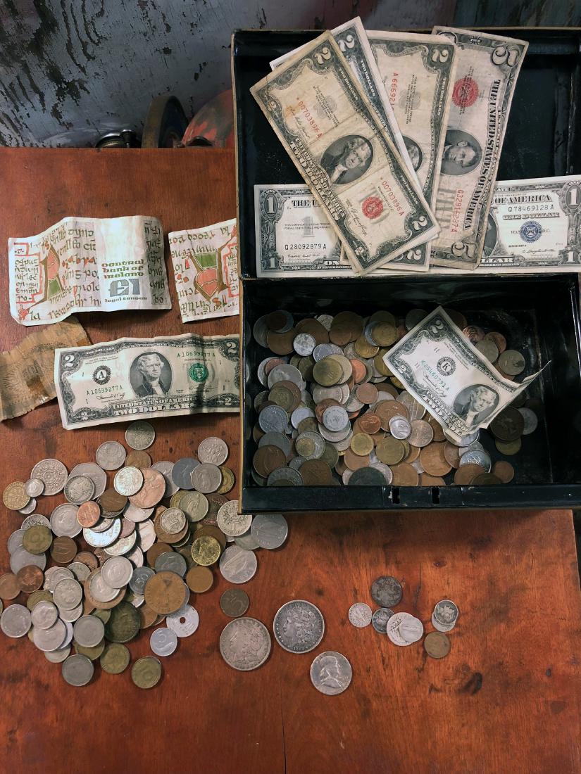 Estate Silver Coins: Estate silver coins including silver dollars and silver currency, plus foreign coins. (strong box not included)