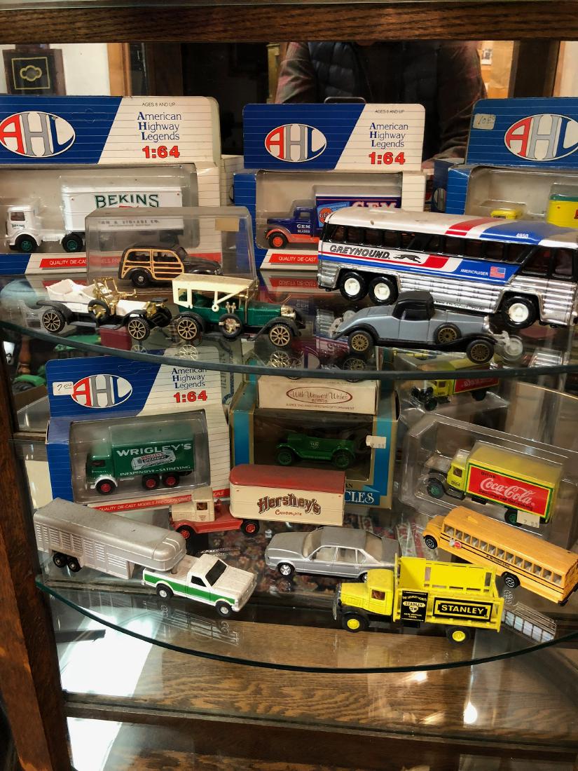 Truck and Automobile Collection: Estate collection of trucks and automobiles, approx 16 pieces, some in original packaging. AHL diecast trucks in original packaging, Greyhound bus, vintage automobiles, etc.
