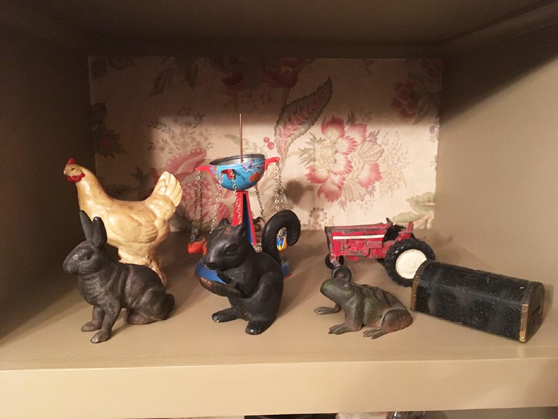 Vintage Estate Collectibles: Vintage Estate collectibles lot includes cast iron bunny and hen coin banks, squirrel nutcracker, flower frog frog, tin toy (is missing top of the globe), tractor, etc.