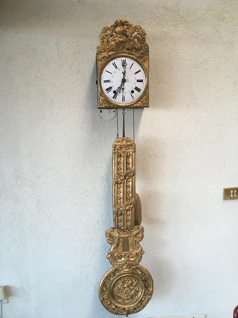 Wag on the Wall Clock: Beautiful gold gilt Wag on the Wall Clock. Nun on top with student, ornate pendulum features fruit bowl. Measures approx. 58â€ tall x 10â€ wide. Pendulum is 12â€ in diameter at base. Pendulum