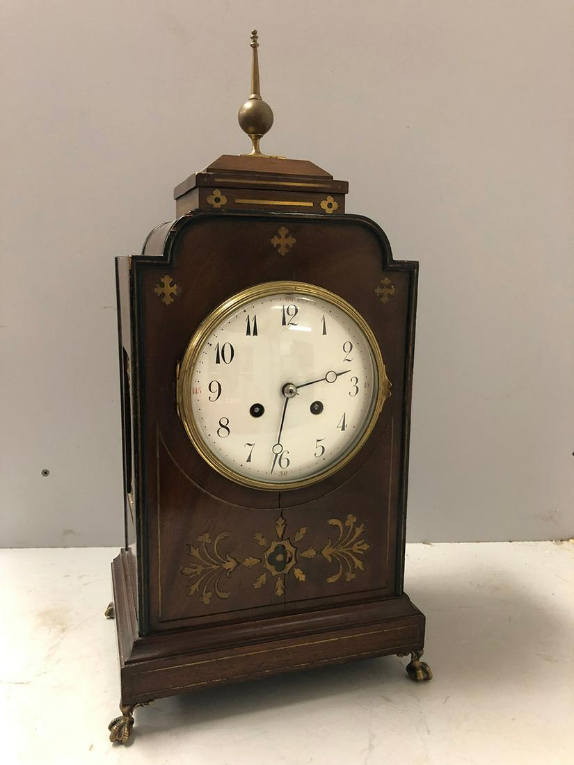 French Mantel Clock: French Mantel Clock, signed movement with unusual brass claw feet & brass inlaid front. Unusual style. Was in working order at the estate. From the Chatham, Ma, Cape Cod Collection.