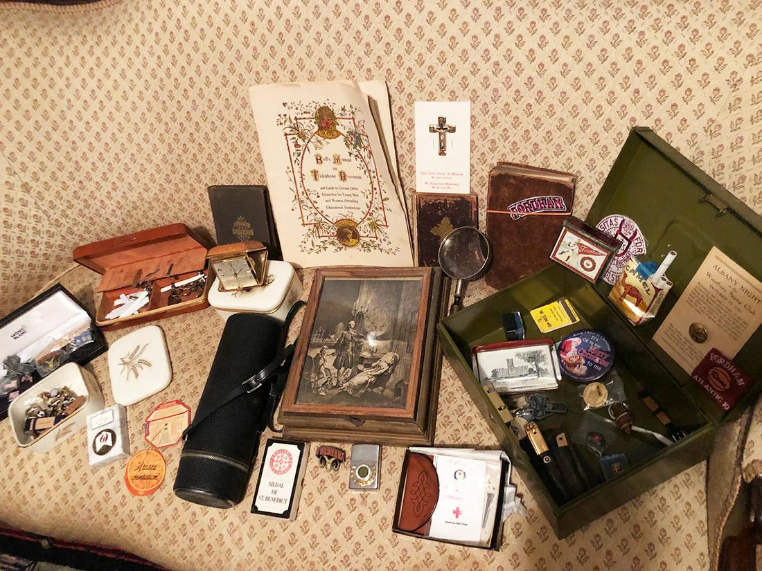 Estate Discovery Lot: Early bibles, strong box with contents, menâ€™s cufflinks, tie pins, Seth Thomas travel clock, Fordham University items, contents of ladyâ€™s jewelry box, some enamel boxes, beads, large tel