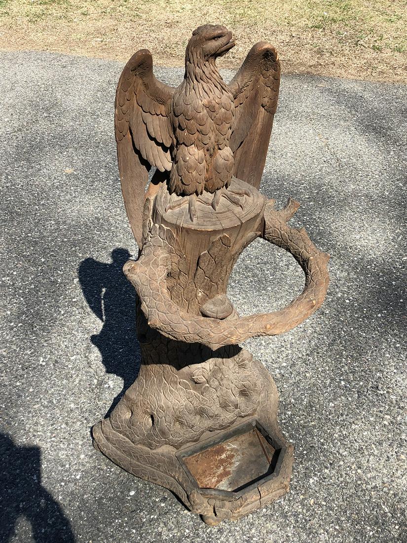 Black Forest Carved Umbrella Stand: Black Forest carved umbrella stand with American Eagle. Beautifully carved with eagle (beak needs repair), wings, on tree stump with branch for umbrellas. Rare find! Measures approx. 37 inches tall x 