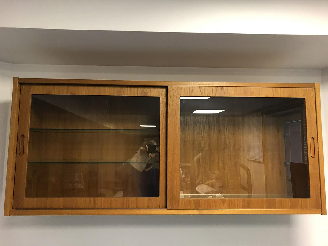Mid-Century Danish, Hundevad, Glass Door Cabinet: Mid-Century Danish, Hundevad, Glass door bookcase/cabinet, can hang on wall or be used as floor unit, can also be used with cabinet Lot #181A. Measures approx. 54.5 inches wide x 12.5 inches deep x 23