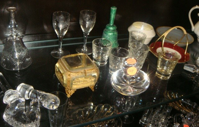 20 Piece Shelf Contents: 5 glass wine decanters, 1w/ horses head, Royal Albert Teapot, cut glass nappie,cut glass belik bell,shot glasses