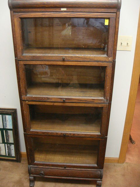 Lundstrom Oak Half Size Sectional Book Case: Lundstrom oak half size sectional book case. Original finish with one drawer base. Unique Find! This is a rare size to find in stacked book case family. Original finish. 25 in. wide x 12 in. deep x 5