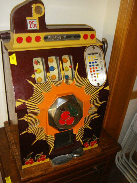 Antique 25 Cent Slot Machine Bursting Cherries: Antique 25 Cent Slot Machine Bursting Cherries. Original key, working order. 16 in. x 15 in. x 25 in.