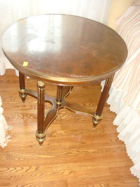 Round French Table with Bronze Decoration: Round French Table with Bronze Decoration. Measures 29 1/2" round x 28" tall.