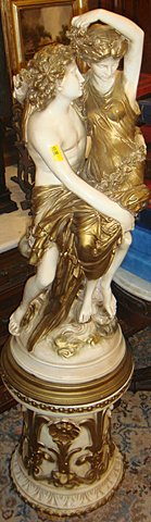 Decorative 2 Part Plaster Statue on Pedestal: Decorative 2 part plaster statue on pedestal, measures 53 inches tall x 13 inches wide. 2 pieces, statue sits on pedestal.