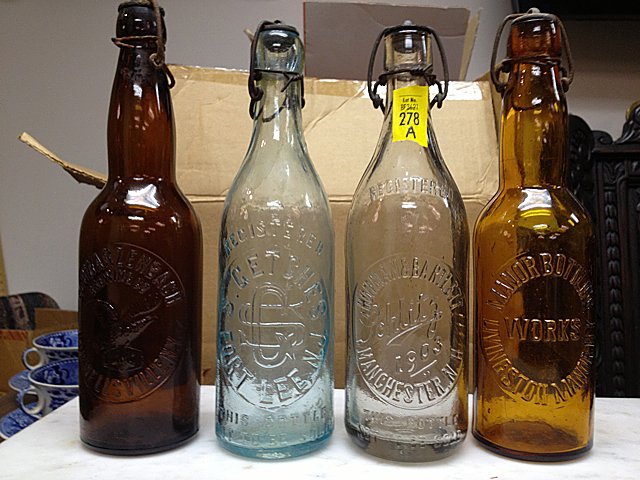 4 Antique Soda/Beer Bottles with Wire Stoppers: 4 Antique Soda/Beer Bottles. 1 brown, 1 aqua, 1 clear, 1 light brown. All have original wire stoppers and are in excellent condition. All of our items are from private collections, estates, and or hav