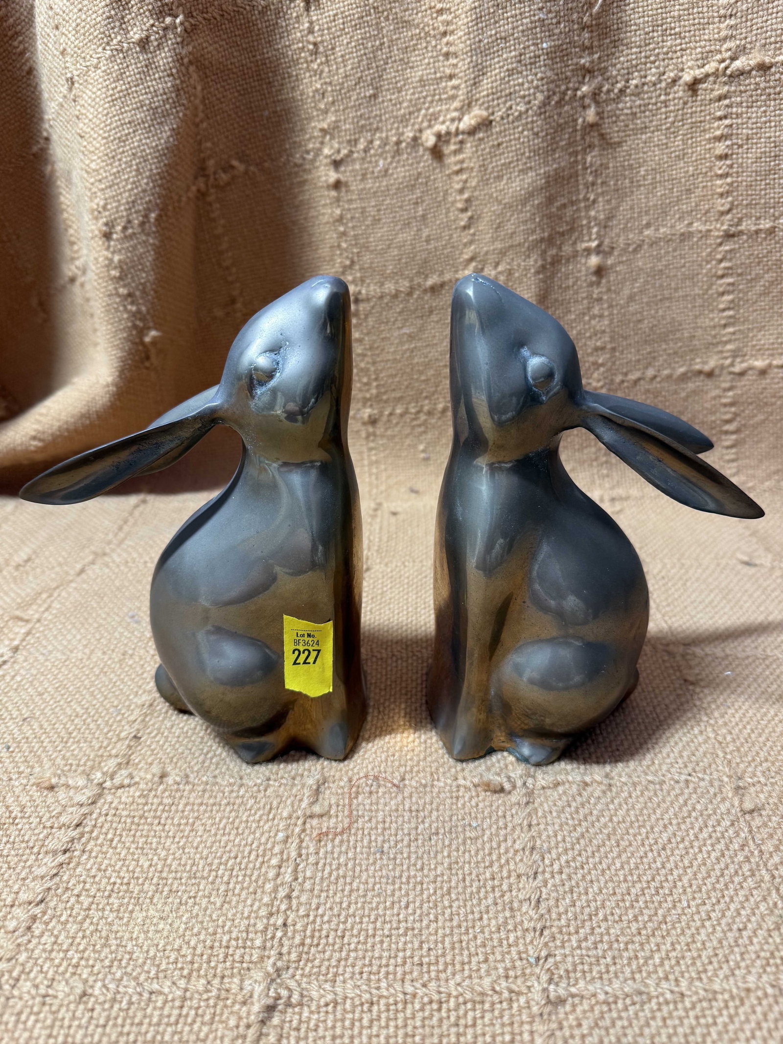 Pair Of Rabbit Bookends: Pair Of Rabbit Bookends, 20th C., metal, with rabbits facing upwards, wear consistent with age and use.