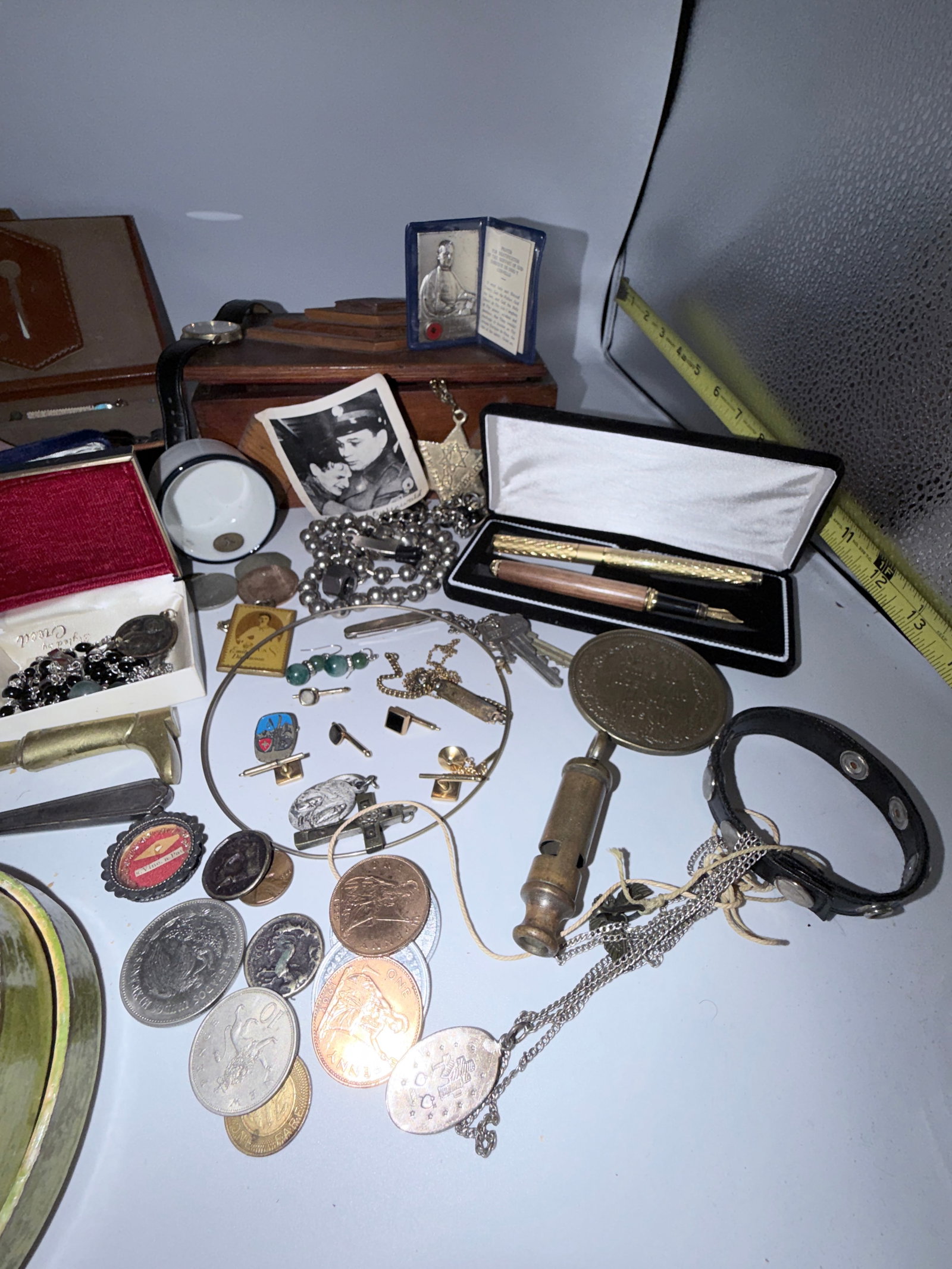 Estate Sale Treasure Trove: This treasure trove from the Killian Estate is a handmade box that contains a gold tipped fountain pen, a police and fire whistle, and several religious items.