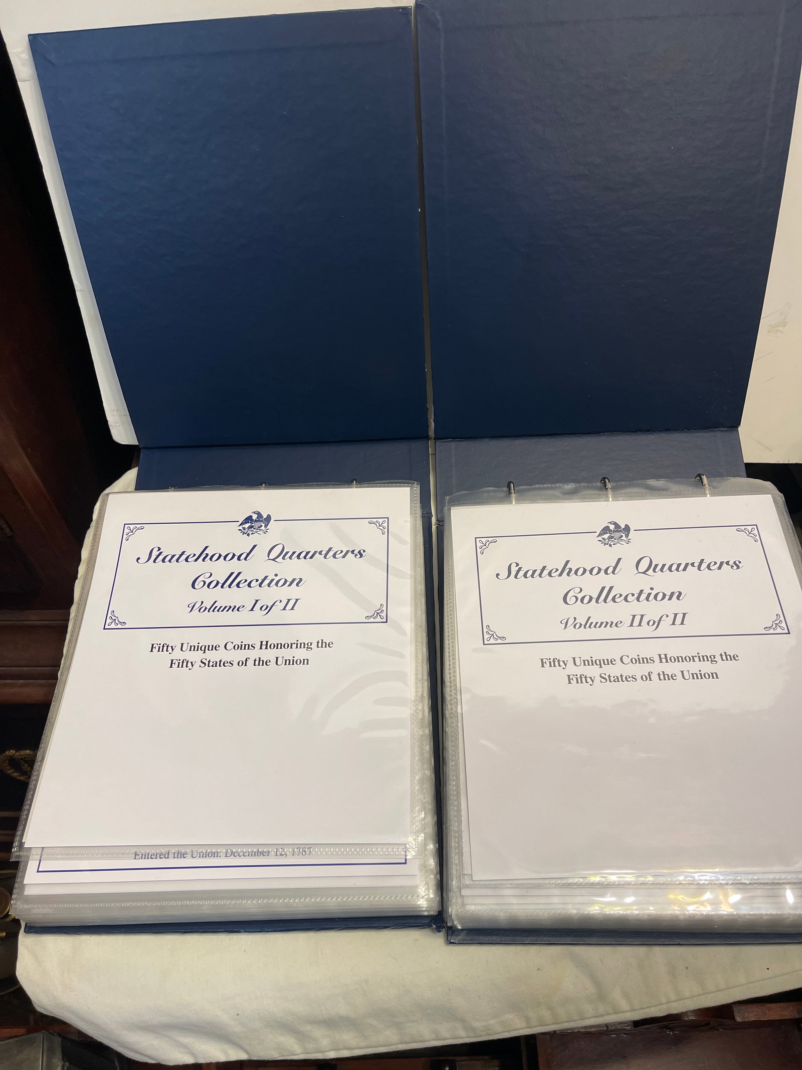 Statehood Quarters Collection Volume 1 and 2: This lot contains two binders that include the statehood quarters collection.