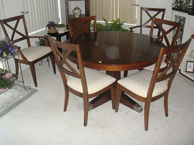 Ethan Allen Dining Room Set: Ethan Allen Dining Room set including round pedestal table, six chairs (2 are arm chairs) and table leaf (all wrapped up). This set was purchased new for over $3,400 with fabric guard on all 6 chairs.