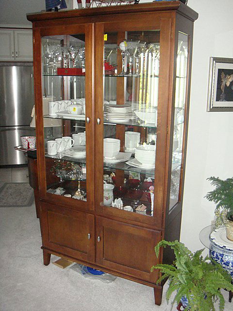 Ethan Allen Curio Cabinet: Ethan Allen Curio Cabinet with 3 plate glass shelves, glass front, glass sides, 2 lower enclosed cabinets at bottom, matches table and chairs lot 40. Curio Cabinet was purchased new for $1,500. Measur