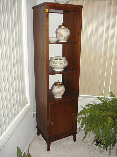 Ethan Allen Open Curio Cabinet: Ethan Allen Open Curio Cabinet with one door at bottom, matches the previous Curio and Table and Chairs (Lots 40 and 41). Was purchased new for $750.00. Measures 18 inches wide x 16 inches deep x 72 i