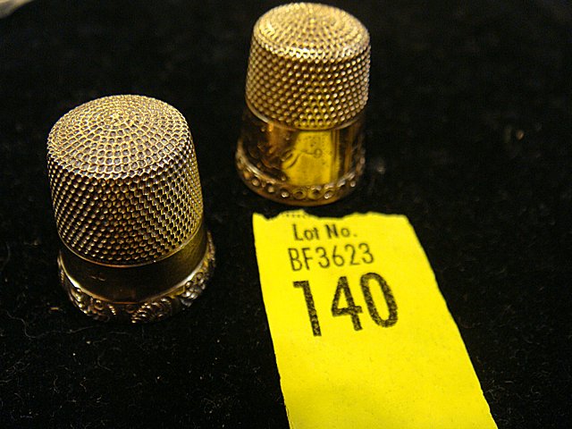 2 Estate 14kt Gold Thimbles: 2 Estate 14kt Gold Thimbles, Victorian Era. 1 has Nautical Scene with sailboats, lighthouse and rising sun. Weighs 5.7 dwts. (dwt is the abbreviation for penny weights). Very nice, unique gold thimble