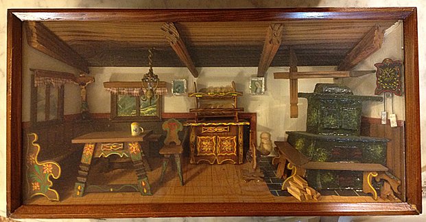 Black Forest Shadow Box: Black Forest Shadow Box, measures 15 inches wide x 7 3/4 inches high x 3 inches deep. Incredibly detailed miniture of Black Forest kitchen, including religiuos art on walls, painted furniture, cuckoo 
