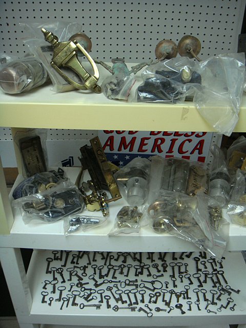 St. Jude Item: Vintage Hardward Shelf Lot: To Benefit St. Jude Children's Research Hospital; Vintage hardware shelf lot including a collection of antique keys with skeleton keys, brass door knockers, hinges, locks, knobs and latches, pair of v