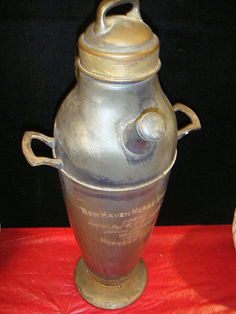 St. Jude Item: Estate Trophy Cocktail Shaker with Music: To Benefit St. Jude Children's Research Hospital; Estate Trophy Cocktail Shaker with Music Box. Engraved "New Haven Horse show, 1929, 102nd Inf. CNG Trphy, Novice Jumpers Won by Herbert Moll". Has wor