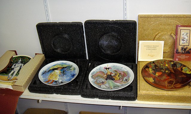 St. Jude Item: 4 Collectors Plates: To Benefit St. Jude Children's Research Hospital; 4 Collector's Plates including The Tin Man from the Wizard of Oz, little girl with umbrella, high fashion, and Paris cafe scene by Sisley. These plate