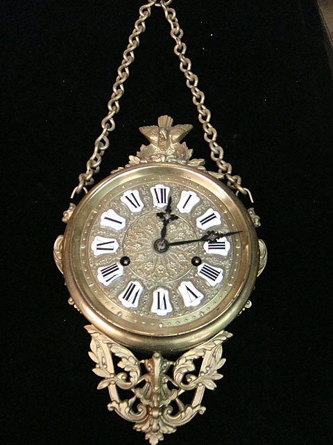 Victorian French Clock: French clock victorian era with brass hanging, has beautiful porcelain numbers on dial, full bird with nest and eggs, griffins, very ornate.