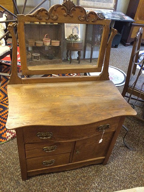 Antique Ladies Wash Stand: Well over 100 years old, with original mirrored back, 1 door 3 drawers base (solid oak), originally used in bedroom for your pitcher and wash bowl set. Measures 33" wide x 27" tall (mirror measures 23