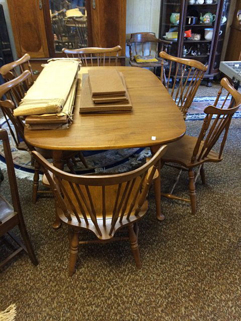 Estate Maple Dining Set: Circa 1950's - 1960's solid maple dining room set with 6 brace back windsor back chairs; 2 arm and 4 side. Table top measures 61" x 39" wide, has 4 leaves with pads, Queen Anne legs. Matching 2 piece