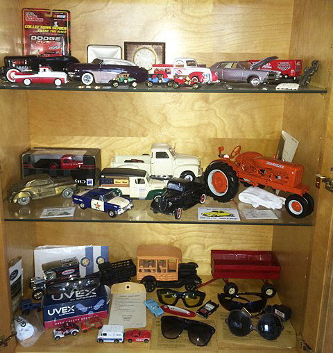 Collectibles Lot: Collectibles lot includes approx. 45 Collectibles; model cars and trucks, pocket knives, desk clock, Safety and sunglasses, misc. memorabilia, etc.