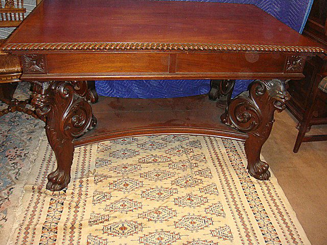 Mahogany "Griffins" Library Table & Chair: Mahogany Fully Carved "Griffins" Library Table with drawer at either end with carved North Wind Faces, rope twist apron top. Huge claw feet original finish. 29 in. tall 31 in. wide 48 in. long. Attrib