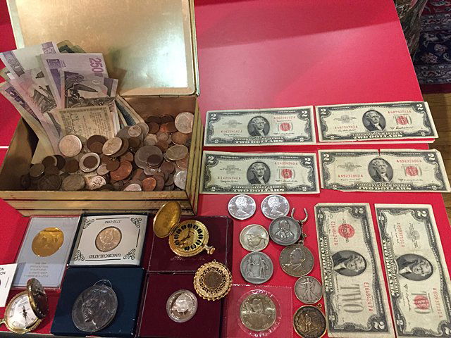 Estate Coin Lot: Estate coin lot, being sold as found, includes foreign and American coins, foreign currancy, $2 bills red stamp serial numbers, commenorative coins, and 2 pocket watches.