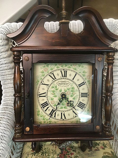 New England Clock Co. Wall Clock: New England Clock Co. weight driven 8 day wall clock, early American style case to look like top of Grandfather clock. Nice, flower design dial, finial, wooden finial.
