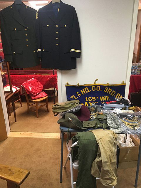 Estate Military Lot: Estate military items includes company banner, uniform coats, hats, berets, khaki, buckles, ties, gloves, patches, watch, gloves, etc. All being sold for 1 monies!