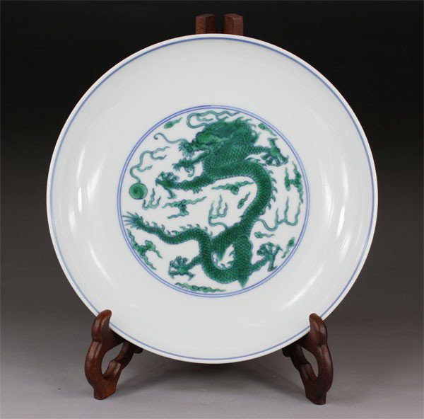 Chinese Porcelain Plate with Green Enamel Dragon: Chinese porcelain plate,The plate is painted in green enameled with the design of dragons playing with a flaming pearl. Six character mark on base "Da Qing Yong Zheng Nian Zhi".H 1.77",Dia 8.27".