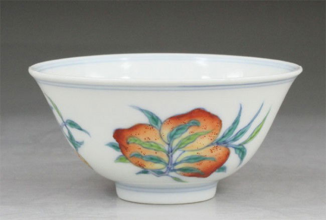Chinese Doucai Porcelain Tea Cup: Chinese Doucai Porcelain Tea Cup.The motif on the cup displayed here includes three fruits--peach-chayote -lichee.Six character mark on base "Da Qing Yong Zheng Nian Zhi"H 1.38", Dia 2.87".