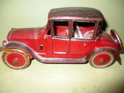 Cast Iron Toy Car Circa 1920: Cast iron toy car, circa 1920, with original paint in good condition. Not marked with maker's name. Measures 9 1/2" long x 4 1/2" tall.