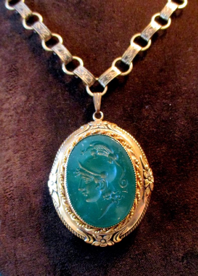 Vintage Locket Set with Glass Carved Intaglio: Lot consisting of one large vintage glass carved intaglio on a gold toned chain in good condition.