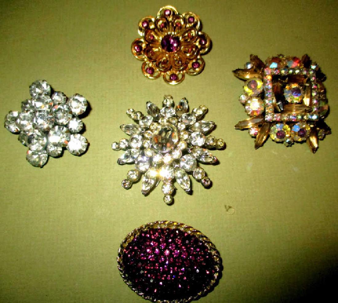 Five Vintage Jewelry Brooches: Lot consisting of 5 vintage jewelry brooches. One is signed Coro. The others are unsigned. All set with rhinestones and in good condition.