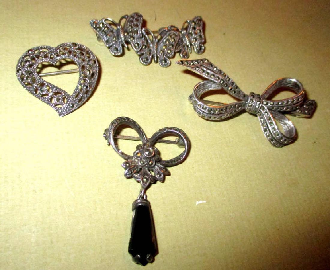 Four Sterling and Marcasite Brooches: Four vintage sterling and marcasites brooches, all seem to be in good condition.