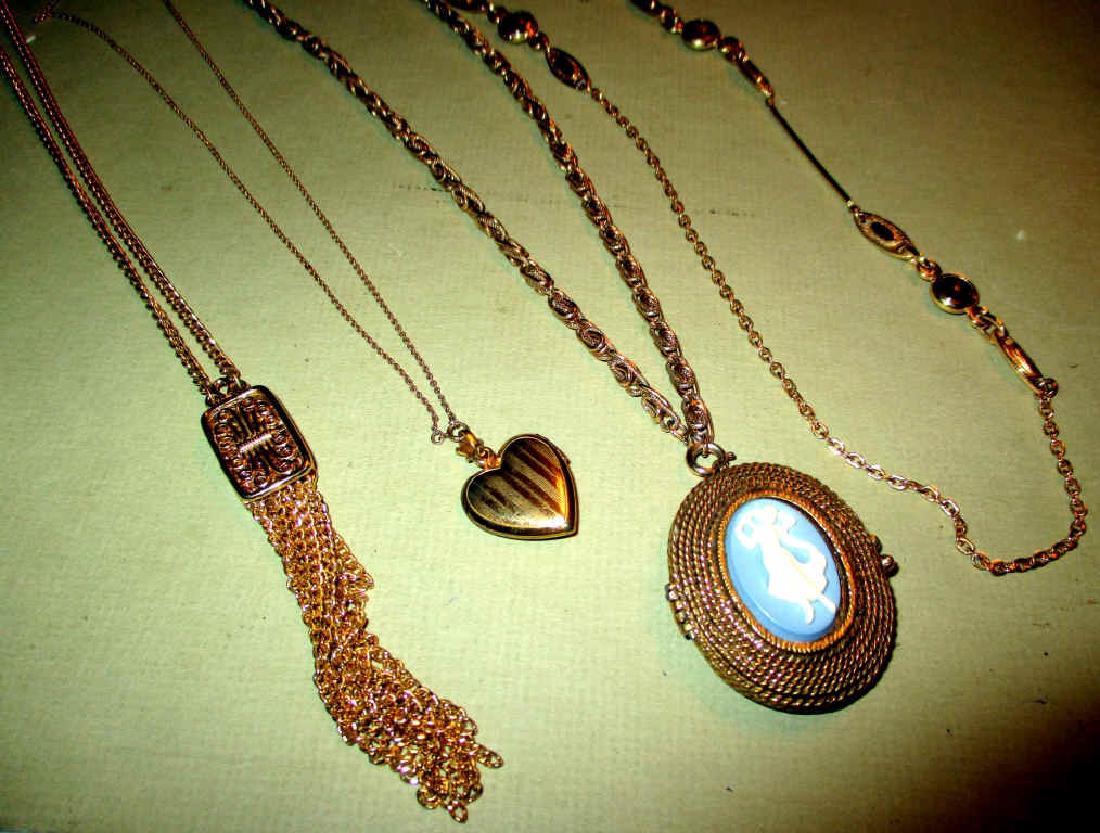 Four Pieces of Costume Jewelry: Lot consisting of a gold toned Sara Cov necklace set with cabochon stone, a Monet gold toned pendant and chain, and a Wedgewood style sache, and a gold toned heart locket on chain. All in good conditi