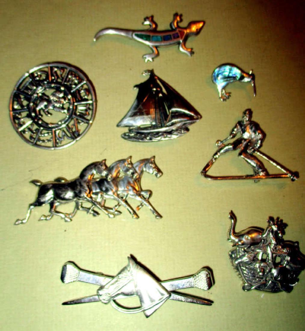 Eight Vintage Sterling Pins: Eight vintage sterling pins, all different motifs. One is inlaid with turquoise and another is inlaid with abalone. All in good condition. Some are signed. One is the zodiac sign for a Libra.