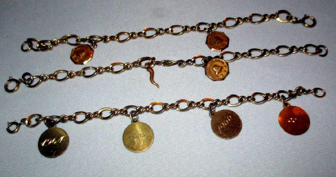 Three Gold and Gold Filled Bracelets: Three gold filled chain link bracelets, two of them have 10k gold Merit award charms attached and one has four gold filled Merit charms. All in good condition.