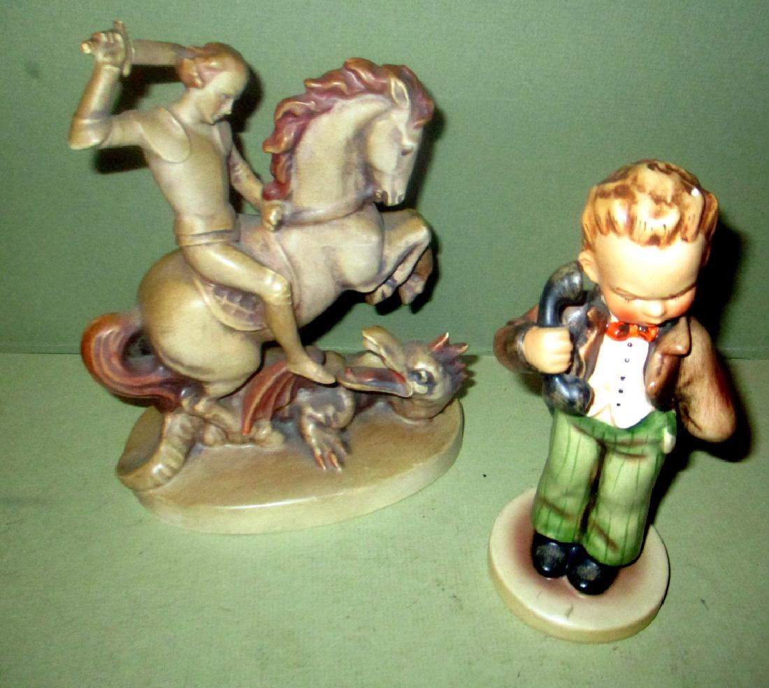 Two Hummels Marked Germany: Two Hummels both marked just "Germany". One of St. George slaying the dragon and one of a boy with phone. Both are in good condition. Both are approx. 7" tall.