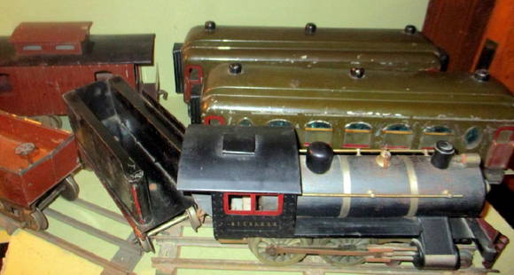 Toy Train Set Circa 1910 MCB Cou[plers: Toy train set consisting of 6 cars and an engine, could not find name except for MCB coupler on one of the cars. Fair condition. Has some railroad tracks as well. Larger than average Train. Has cattle