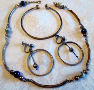 Lot of Sterling Silver Jewelry: Four pieces of sterling jewelry: one necklace w/ lapis beads, a pair of earrings and a bangle bracelet. Good condition. Necklace measures 15" inches long.