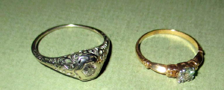 Two Gold Lady's Diamond Rings: One ring is an 18K white gold Deco set with a small diamond in the center of a filagree setting and is approximately size 9. The other ring is 14K yellow gold set with a small diamond and size 6 