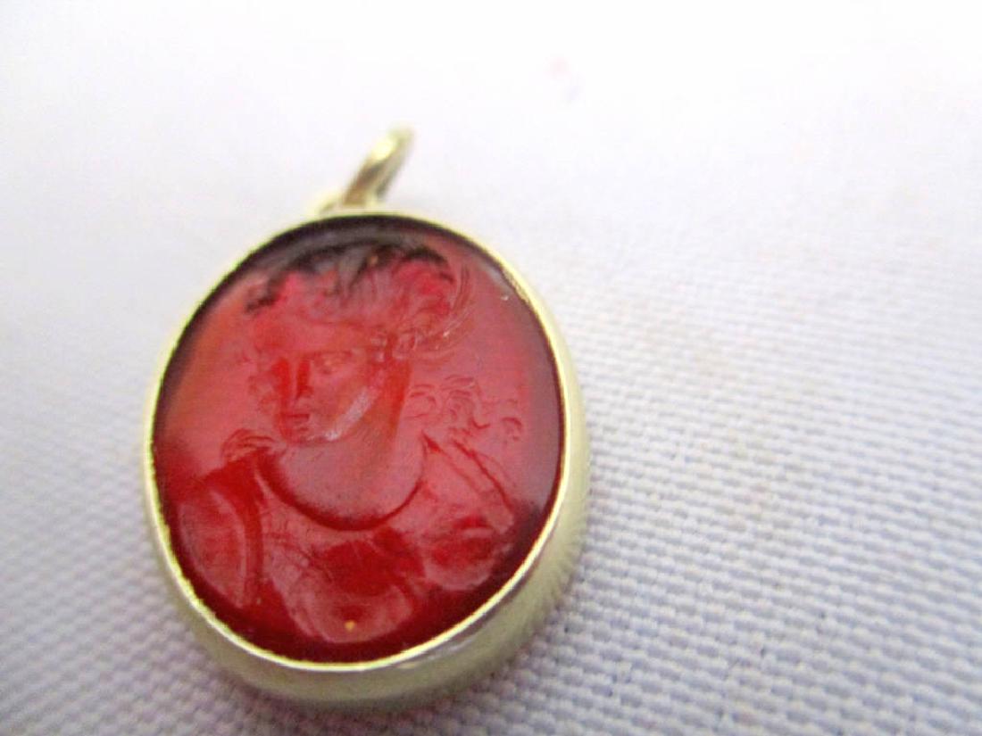 Victorian Lady's Intaglio Pendant: Lady's intaglio pendant with the image of a Victorian lady carved on one side and a rose carved on the other. Set in 14k gold bezel. The stone looks like pink-ish ruby?