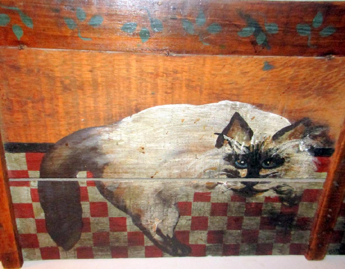 Folk Art Painting of Cat: Folk art painting of cat. It is painted onto the top of a box cover. Approx. 14" inches tall by 21" inches wide. It is signed lower right "Diane".