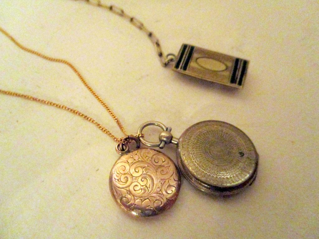Lot of Gold Filled Jewelry: Lot consists of a gold filled neck chain with two lockets, one had a photo in it. They hang from a gold filled neck chain, the other is a pocket watch chain has a belt loop. All in good condition.