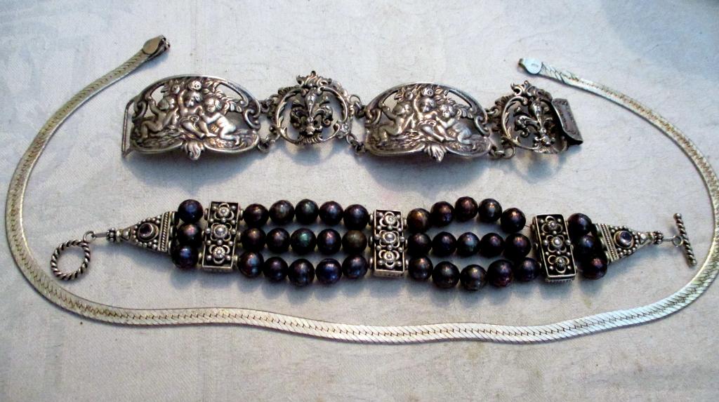 Three Piece Lot of Silver Jewelry: Lot consists of 2 bracelets and a neck chain. The sterling bracelet is stamped Sterling/Boston. One bracelet is set with black pearls and